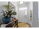 Inviting entryway with a stylish console table, decorative accents, and a bright front door with transom window at 15098 Newburyport Dr, Fortville, IN 46040