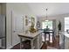 Kitchen and dining area with bright white cabinets, stainless steel appliances, and quartz countertops at 15098 Newburyport Dr, Fortville, IN 46040
