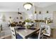 Open-concept kitchen and living area with pendant lighting, ceiling fan, and vaulted ceilings at 15098 Newburyport Dr, Fortville, IN 46040