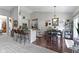 Open-concept kitchen and dining area features a breakfast bar, kitchen island, and modern appliances at 15098 Newburyport Dr, Fortville, IN 46040