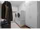 Well-organized laundry room with a washer, dryer, cabinets, and a rack for hanging clothes at 15098 Newburyport Dr, Fortville, IN 46040