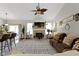 Bright and spacious living area with a fireplace, television, and access to the kitchen and sliding glass door to outside at 15098 Newburyport Dr, Fortville, IN 46040