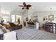 Open concept living room with vaulted ceilings, a large sectional, a fireplace, and seamless flow to other living spaces at 15098 Newburyport Dr, Fortville, IN 46040