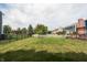 Large backyard with a green lawn, mature trees, wooden pergola, and fenced perimeter at 1521 Midnight Pass, Brownsburg, IN 46112