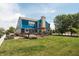 A well-manicured lawn with a wooden deck, pergola, a blue-sided two-story home and privacy fence at 1521 Midnight Pass, Brownsburg, IN 46112