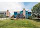 A well-manicured lawn with a wooden deck, pergola, a blue-sided two-story home and white privacy fence at 1521 Midnight Pass, Brownsburg, IN 46112