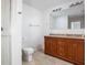 Bright bathroom featuring a double sink vanity, shower, and a toilet at 1521 Midnight Pass, Brownsburg, IN 46112