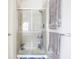 Bathroom with a glass-enclosed shower, neutral tiles, and towel racks at 1521 Midnight Pass, Brownsburg, IN 46112