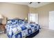 Bedroom with carpet, a fan, and a bed, leading to an ensuite bathroom with a view of a white bathtub at 1521 Midnight Pass, Brownsburg, IN 46112