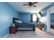 Cozy blue bedroom with modern decor and a ceiling fan at 1521 Midnight Pass, Brownsburg, IN 46112