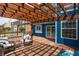 A wooden deck with a pergola, wicker chairs, with a view of the blue sided home and privacy fence at 1521 Midnight Pass, Brownsburg, IN 46112