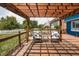 A wooden deck with a pergola, wicker chairs, with a view of the privacy fence and lawn at 1521 Midnight Pass, Brownsburg, IN 46112