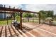 A wooden deck with a pergola, wicker chairs, with a view of the lawn and white privacy fence at 1521 Midnight Pass, Brownsburg, IN 46112