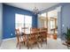 Dining room featuring blue accent walls, traditional chandelier and a view to the foyer at 1521 Midnight Pass, Brownsburg, IN 46112