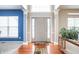 Welcoming entryway with hardwood floors, a transom window, and decorative columns framing the door at 1521 Midnight Pass, Brownsburg, IN 46112