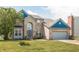 Charming two-story brick home with manicured lawn, blue trim, and attached two-car garage at 1521 Midnight Pass, Brownsburg, IN 46112
