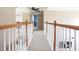 Upstairs hallway with white wood railing and view of downstairs at 1521 Midnight Pass, Brownsburg, IN 46112