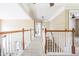 Upstairs hallway features neutral carpet, a white railing, and views into other rooms at 1521 Midnight Pass, Brownsburg, IN 46112