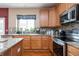 Well-lit kitchen with granite countertops, stainless steel appliances, and tile backsplash at 1521 Midnight Pass, Brownsburg, IN 46112