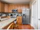 Kitchen featuring stainless appliances, granite countertops, and light wood cabinetry with silver hardware at 1521 Midnight Pass, Brownsburg, IN 46112