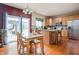 Bright kitchen with stainless steel appliances, granite counters, and sliding door to the outside patio at 1521 Midnight Pass, Brownsburg, IN 46112