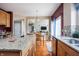 Open concept kitchen with granite countertops, and views of the dining and living areas at 1521 Midnight Pass, Brownsburg, IN 46112