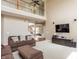 Expansive living room with high ceilings, large sectional sofa, and entertainment center at 1521 Midnight Pass, Brownsburg, IN 46112