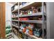 A well stocked pantry with many food and beverage items on the shelves at 1521 Midnight Pass, Brownsburg, IN 46112
