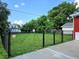 Fenced backyard with established trees and a large grass area at 160 E Elm St, Morgantown, IN 46160