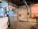 Basement with a water filtration system, hot water tank, and unfinished walls, showcasing the home's utilities at 160 E Elm St, Morgantown, IN 46160