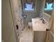 Bathroom featuring white vanity, floral shower curtain, and marble style tile flooring at 160 E Elm St, Morgantown, IN 46160