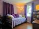 Bedroom offering a cozy daybed with purple accents, hardwood floors, and natural lighting at 160 E Elm St, Morgantown, IN 46160