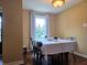 Bright dining room featuring a table set for dinner and a view of the outdoors at 160 E Elm St, Morgantown, IN 46160