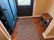 Cozy entryway with hardwood floors, a rustic wooden bench, and a stylish doormat at 160 E Elm St, Morgantown, IN 46160