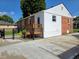 Back exterior of the home and back patio with mature trees for shade at 160 E Elm St, Morgantown, IN 46160
