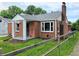 Charming brick home featuring a cozy front porch and well-maintained landscaping at 160 E Elm St, Morgantown, IN 46160