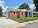 Quaint brick bungalow featuring an attached garage, beautiful landscaping and a well-maintained lawn, providing a welcoming atmosphere at 160 E Elm St, Morgantown, IN 46160
