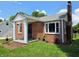 Charming brick home featuring a covered front porch, well-maintained lawn, and mature landscaping, offering inviting curb appeal at 160 E Elm St, Morgantown, IN 46160