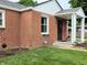 Charming brick home showcasing a covered front porch and tidy landscaping at 160 E Elm St, Morgantown, IN 46160