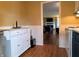 View of kitchen with island and transition to living room with fireplace at 160 E Elm St, Morgantown, IN 46160