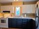 Traditional kitchen featuring two-tone cabinets, laminate countertops, and stainless steel appliances at 160 E Elm St, Morgantown, IN 46160