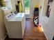 Bright laundry room with wood look floors, washer, and dryer hookups at 160 E Elm St, Morgantown, IN 46160