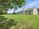 Spacious backyard featuring a playset, mature trees, and lush green lawn at 1702 Juniper Ln, Greenwood, IN 46143