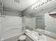 Bathroom featuring a tub and shower, a mirror, and a toilet at 1702 Juniper Ln, Greenwood, IN 46143
