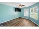 Bright bedroom featuring new floors, a ceiling fan, and two windows with a pleasant view at 1702 Juniper Ln, Greenwood, IN 46143