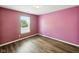 Bedroom featuring wood-look floors and a window letting in natural light at 1702 Juniper Ln, Greenwood, IN 46143