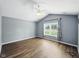 Bright bedroom featuring vaulted ceilings, a modern ceiling fan, and beautiful wood-look floors at 1702 Juniper Ln, Greenwood, IN 46143