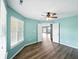 Large bedroom featuring new floors, a ceiling fan, and an attached en-suite bathroom at 1702 Juniper Ln, Greenwood, IN 46143