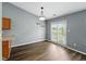Eat-in kitchen features new floors, a new light fixture, and access to the backyard at 1702 Juniper Ln, Greenwood, IN 46143