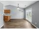 Eat-in kitchen features new floors, a vaulted ceiling, a new light fixture, and access to the backyard at 1702 Juniper Ln, Greenwood, IN 46143